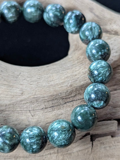 Close-up of 11mm Seraphinite (Clinochlore) Bracelet, detailing pristine polish and intricate mineral patterns.