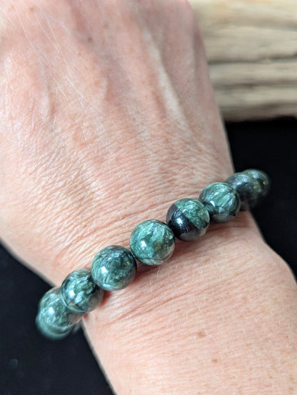 Substantial 11mm Seraphinite (Clinochlore) Bracelet shown worn on a wrist.