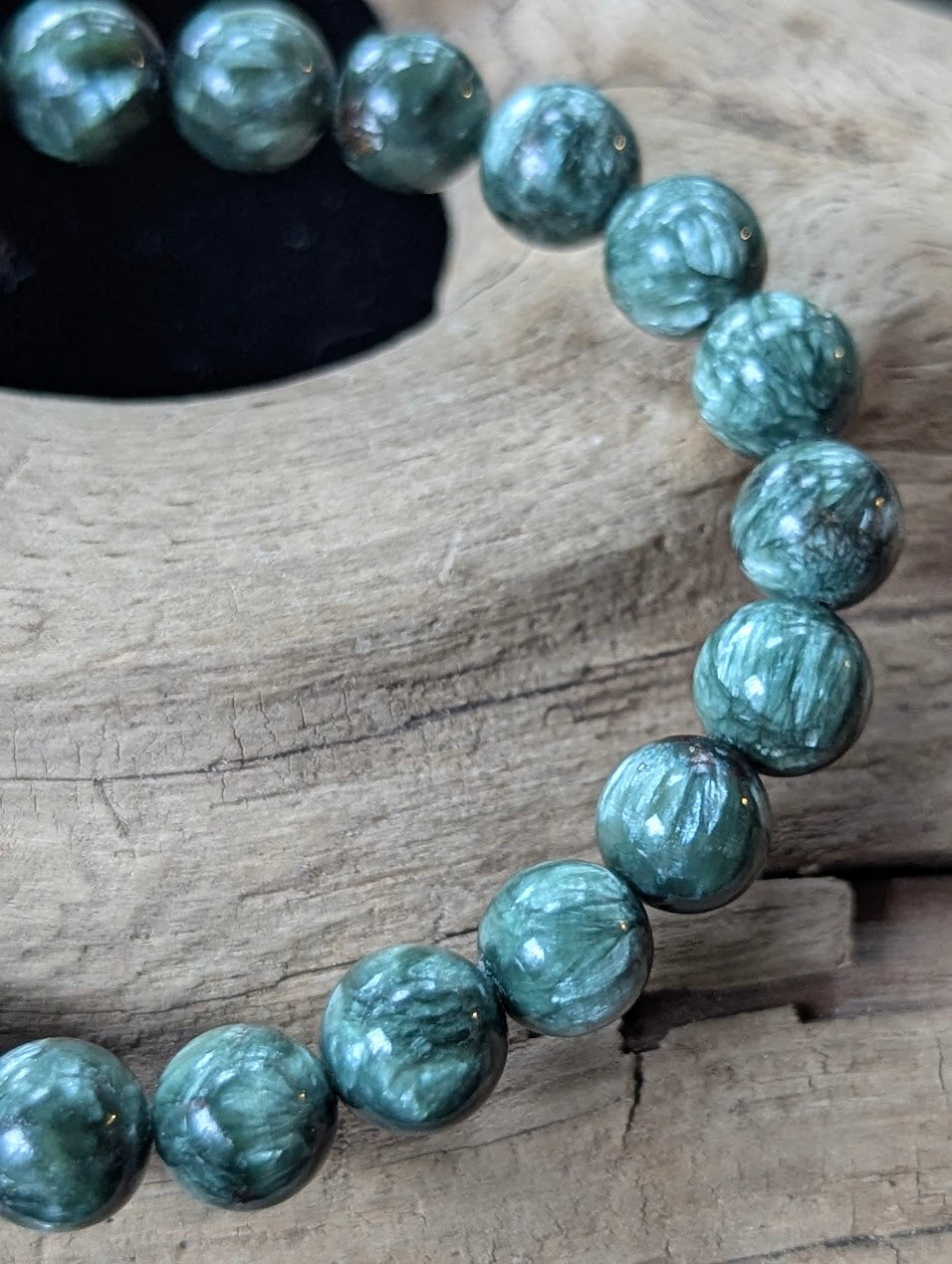 Close-up of 8mm Seraphinite (Clinochlore) Bracelet, detailing the chatoyant silver mica inclusions.