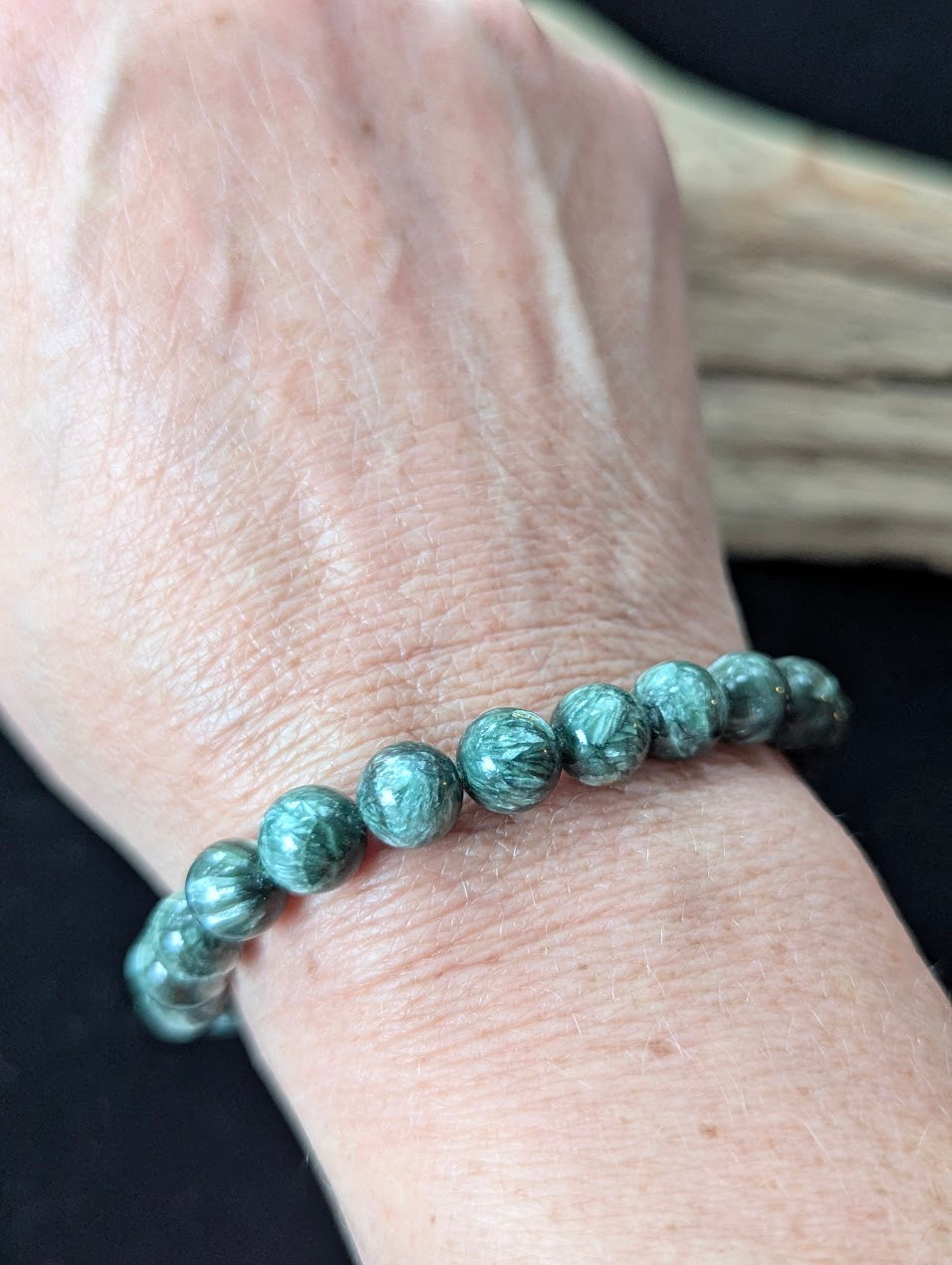 8mm Seraphinite (Clinochlore) Bracelet shown worn on a wrist, illustrating scale and polish.