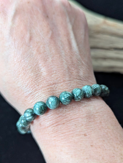 8mm Seraphinite (Clinochlore) Bracelet shown worn on a wrist, illustrating scale and polish.