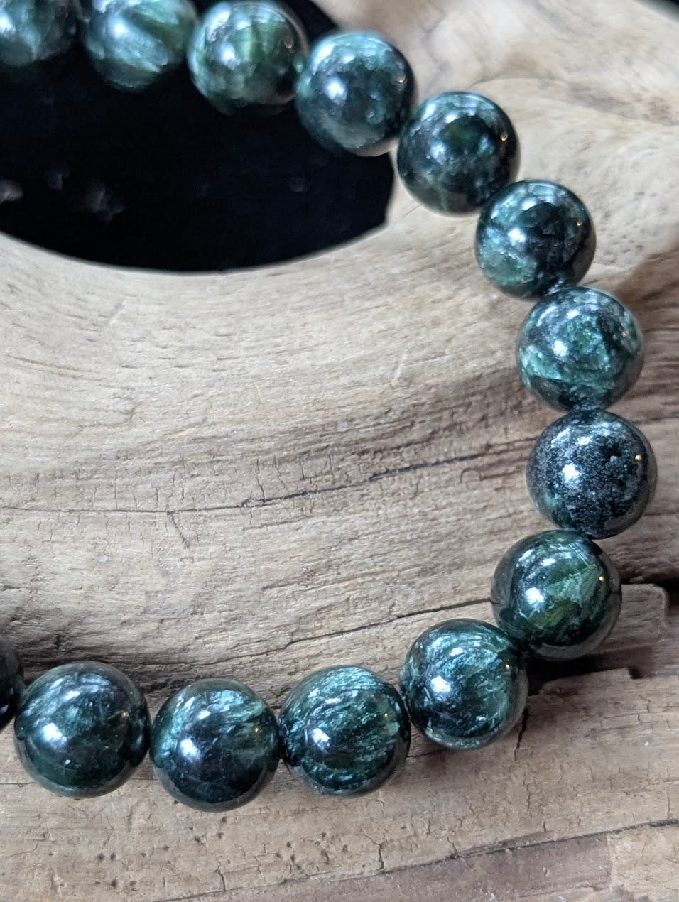 Close-up of 9mm Seraphinite (Clinochlore) Bracelet, highlighting the high-gloss polish and feathery patterns.