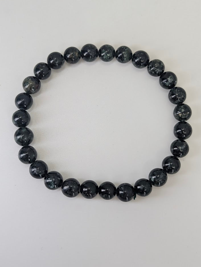 Detailed view of Seraphinite beads showing angel-wing chatoyance