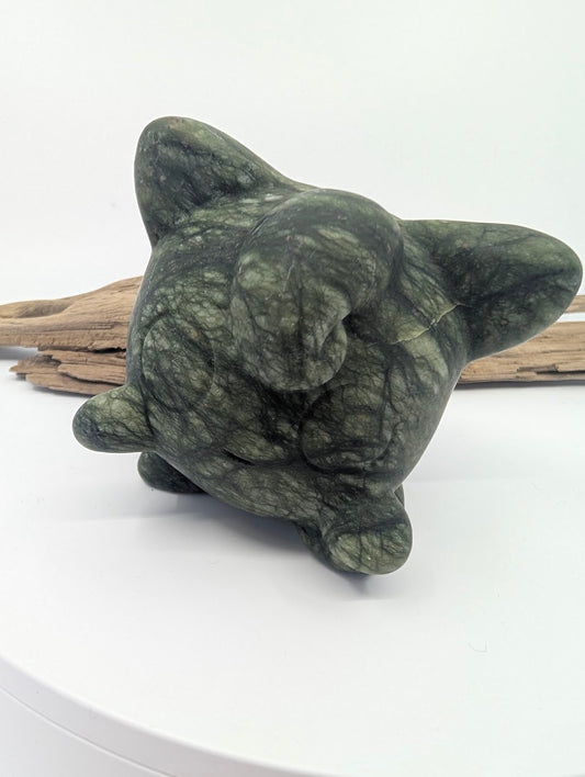 Hand-carved green Serpentine Jigglypuff figurine showing natural dark veining and waxy luster.