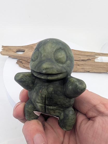 250g Serpentine Squirtle mineral carving held in hand to show size and smooth hand-sculpted detail