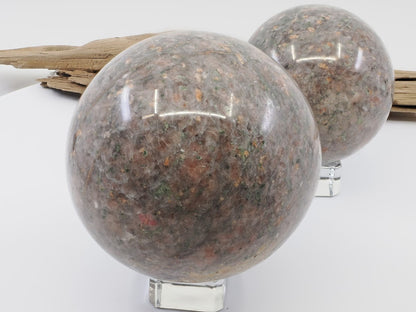 Large 80mm Sesame Jade sphere featuring red Almandine Garnet inclusions in a grey granite matrix.