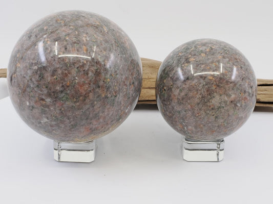 Pair of Sesame Jade (Garnet Granodiorite) spheres 80mm and 60mm displayed on crystal stands.