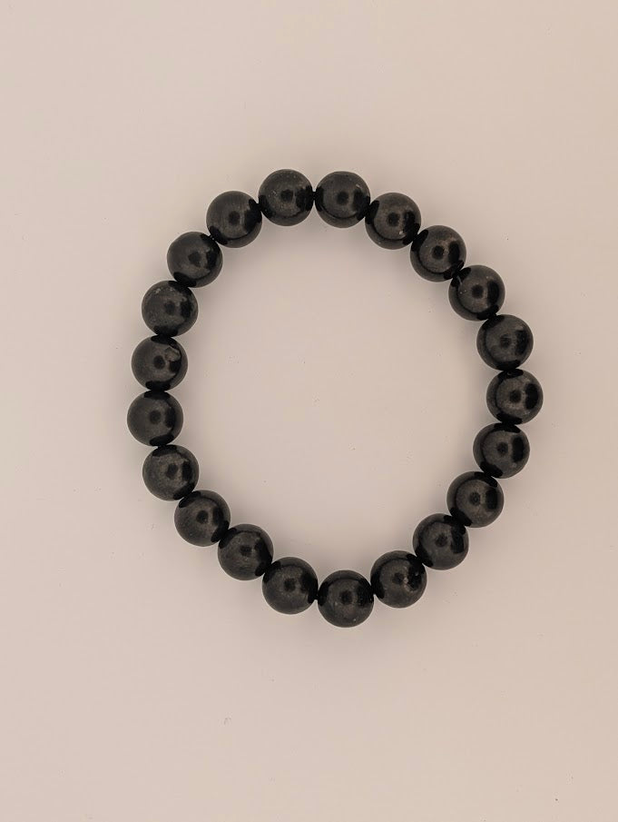 Detail of 8MM polished Shungite beads with natural luster