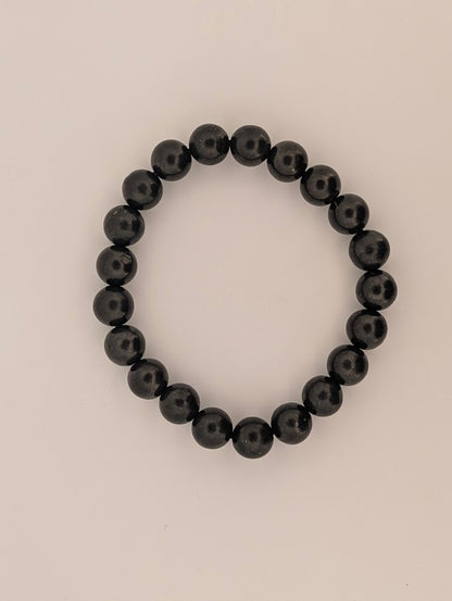 Detail of 8MM polished Shungite beads with natural luster