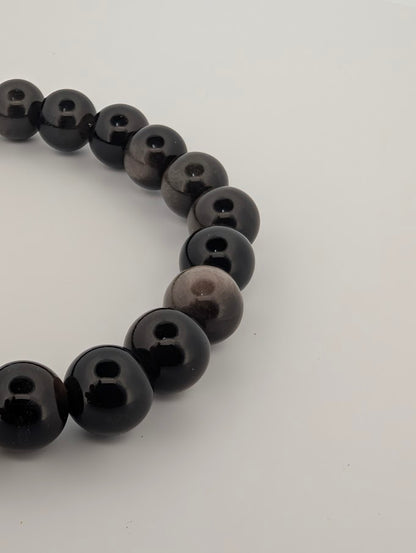 Detail of silver obsidian bracelet highlighting reflective silver clouds in beads