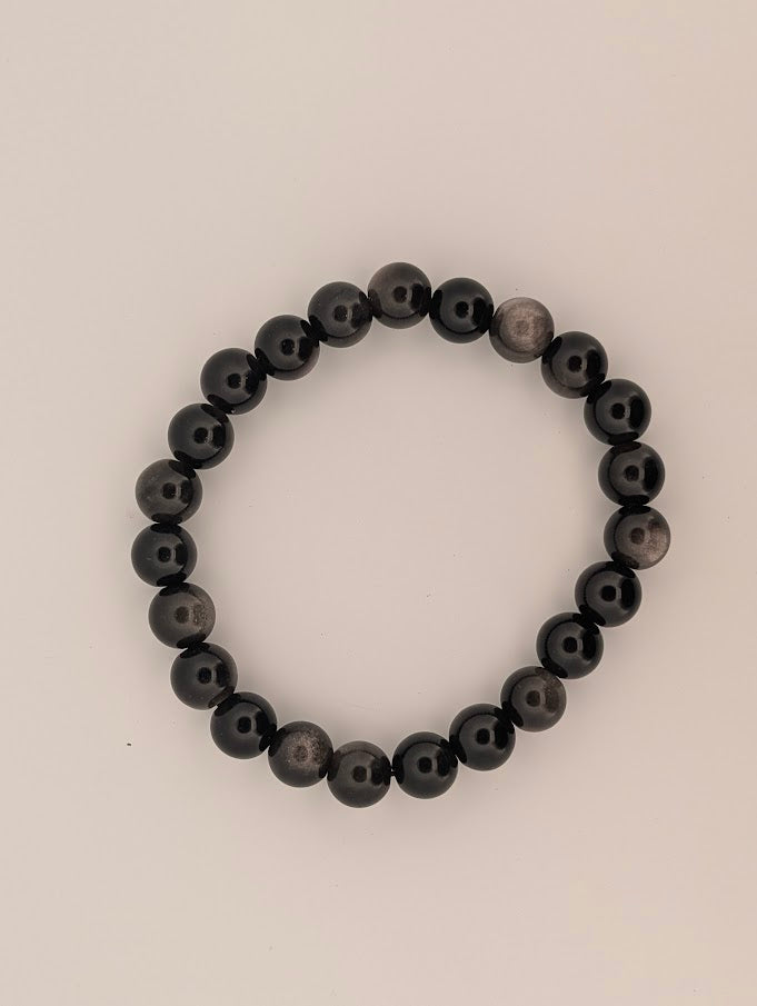 Top-down view of 8mm silver sheen obsidian bracelet on white background