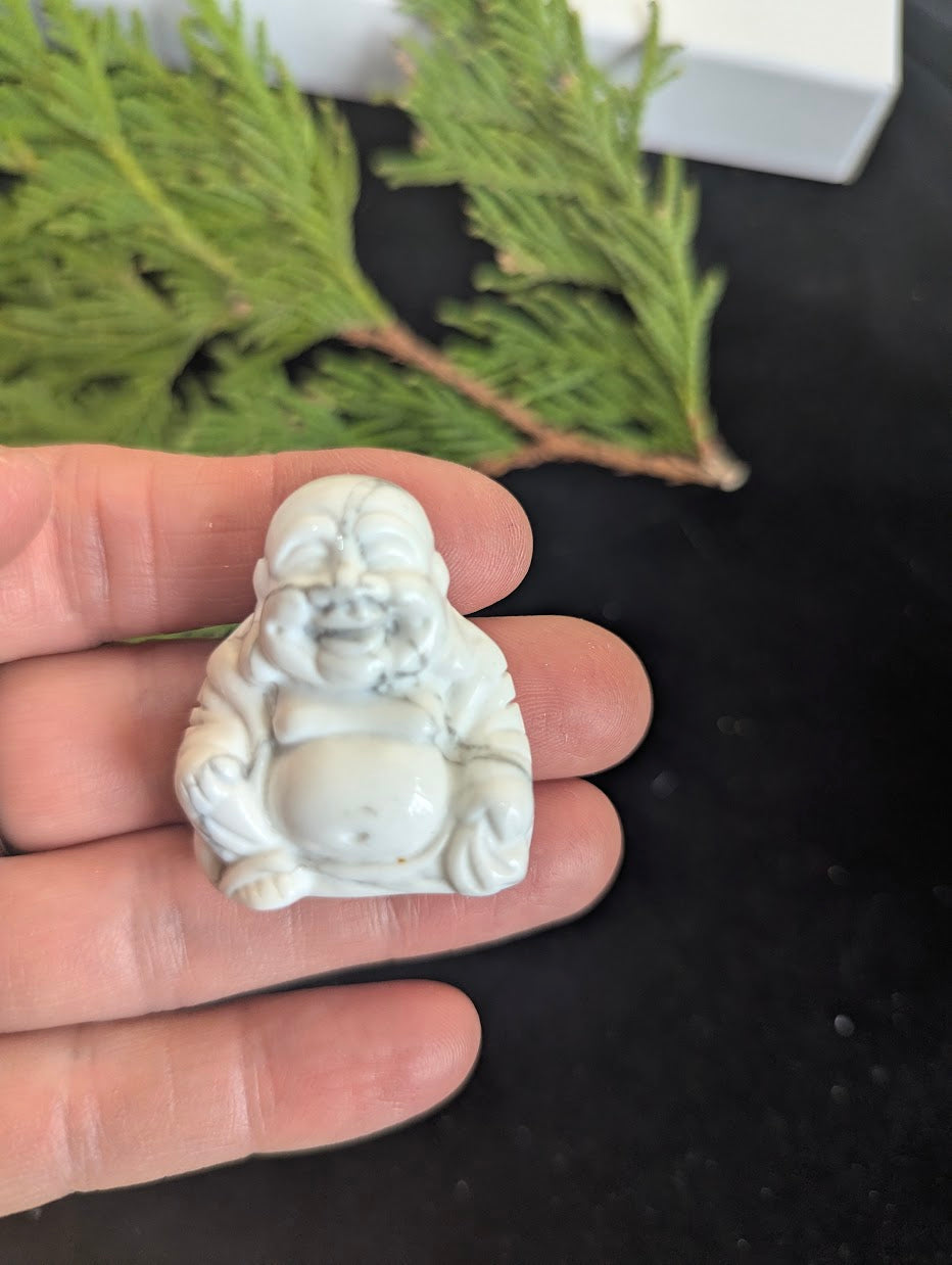 Front view of a 3.5cm Laughing Buddha carved from natural white Howlite.