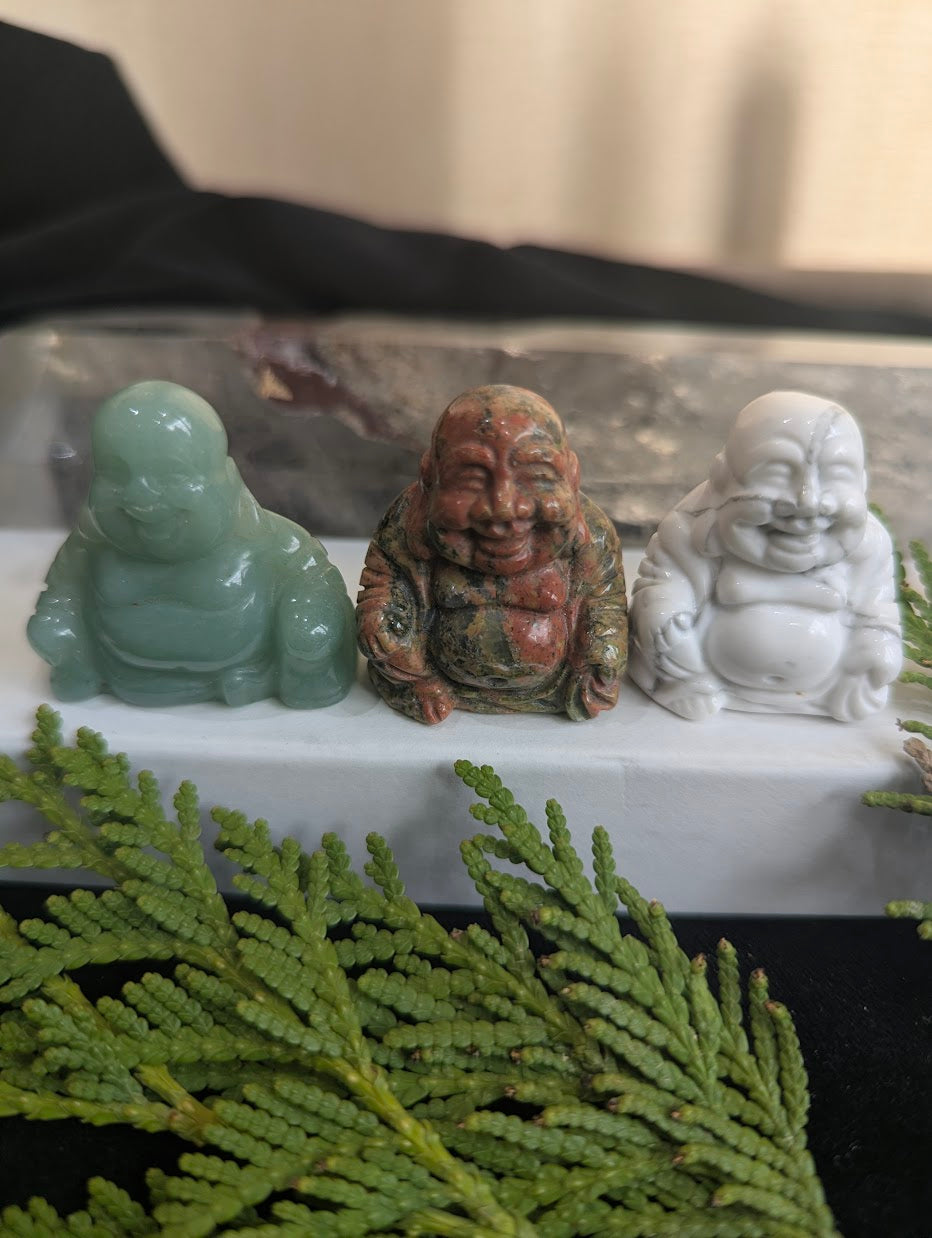 A group of three precision-carved Laughing Buddha totems in Green Aventurine, Unakite, and Howlite.