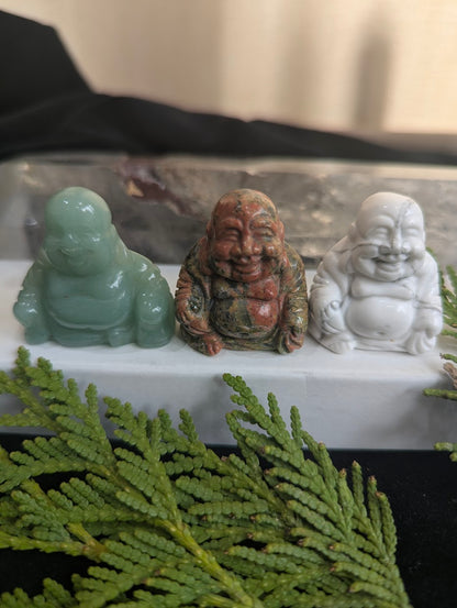 A group of three precision-carved Laughing Buddha totems in Green Aventurine, Unakite, and Howlite.