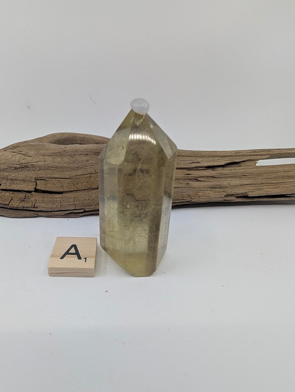 Polished Smoky Citrine tower Piece A from Brazil, 62mm tall, in a standing display.