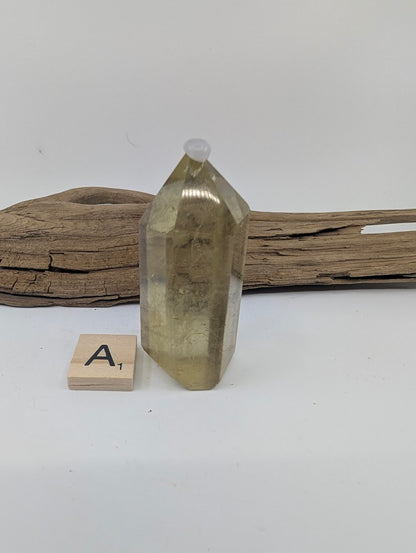 Polished Smoky Citrine tower Piece A from Brazil, 62mm tall, in a standing display.