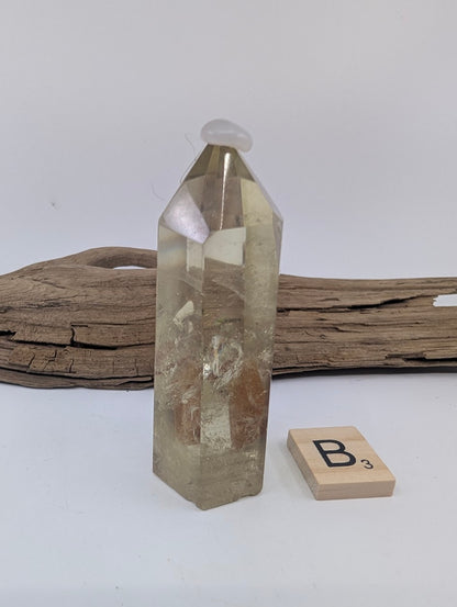 Polished Smoky Citrine tower Piece B from Brazil, 78mm tall, in a standing display.