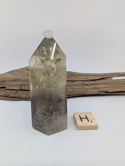 Polished Smoky Citrine tower Piece H from Brazil, 80mm tall, showing a distinct dark base and clear apex.