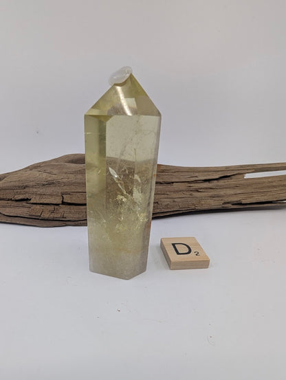Polished Smoky Citrine tower Piece D from Brazil, 83mm tall, showing a distinct horizontal internal plane.