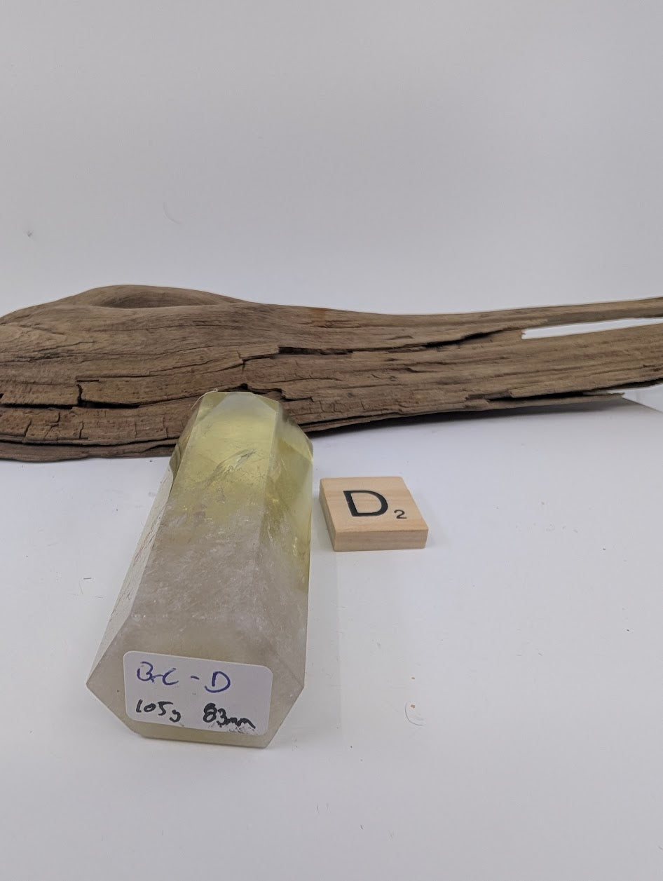 Polished Smoky Citrine tower Piece D from Brazil showing its 105g and 83mm measurement label.