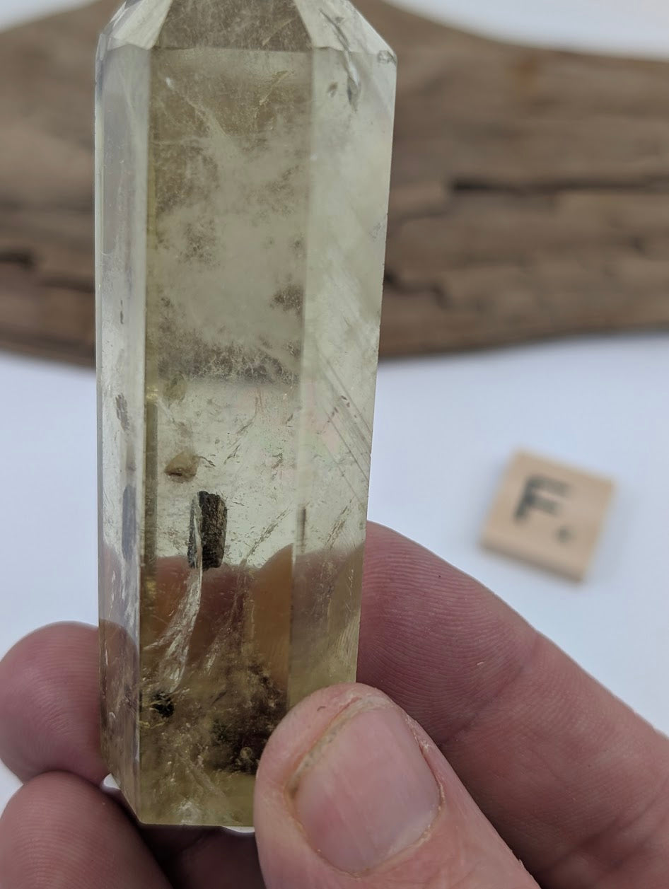 Close up of Piece F, an 84mm polished Smoky Citrine tower from Brazil showcasing a floating mineral inclusion.