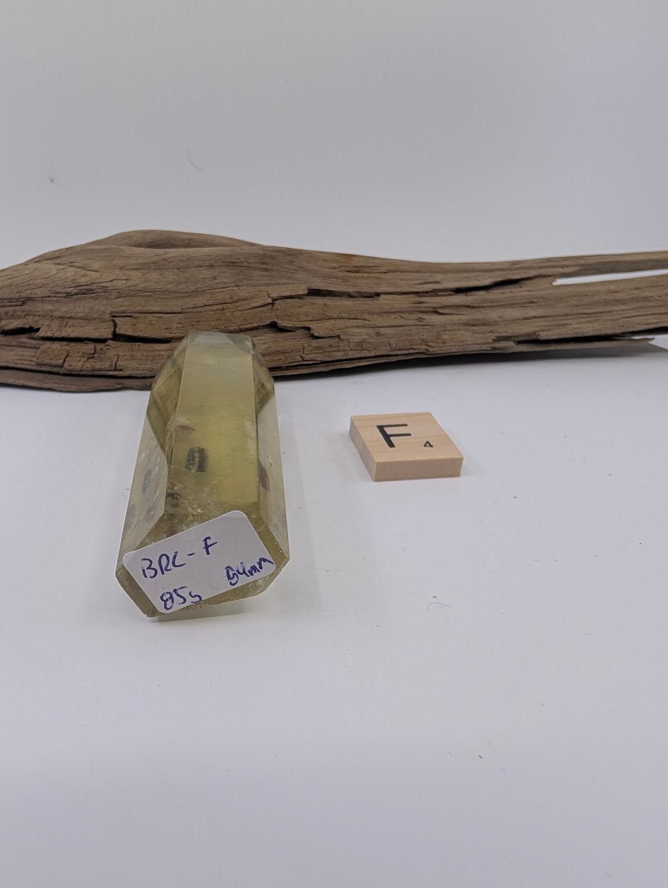 Close up of Piece F, an 84mm polished Smoky Citrine tower from Brazil showcasing a floating mineral inclusion.