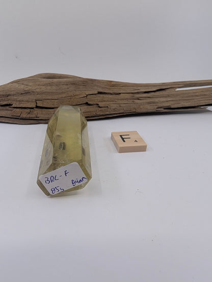 Close up of Piece F, an 84mm polished Smoky Citrine tower from Brazil showcasing a floating mineral inclusion.