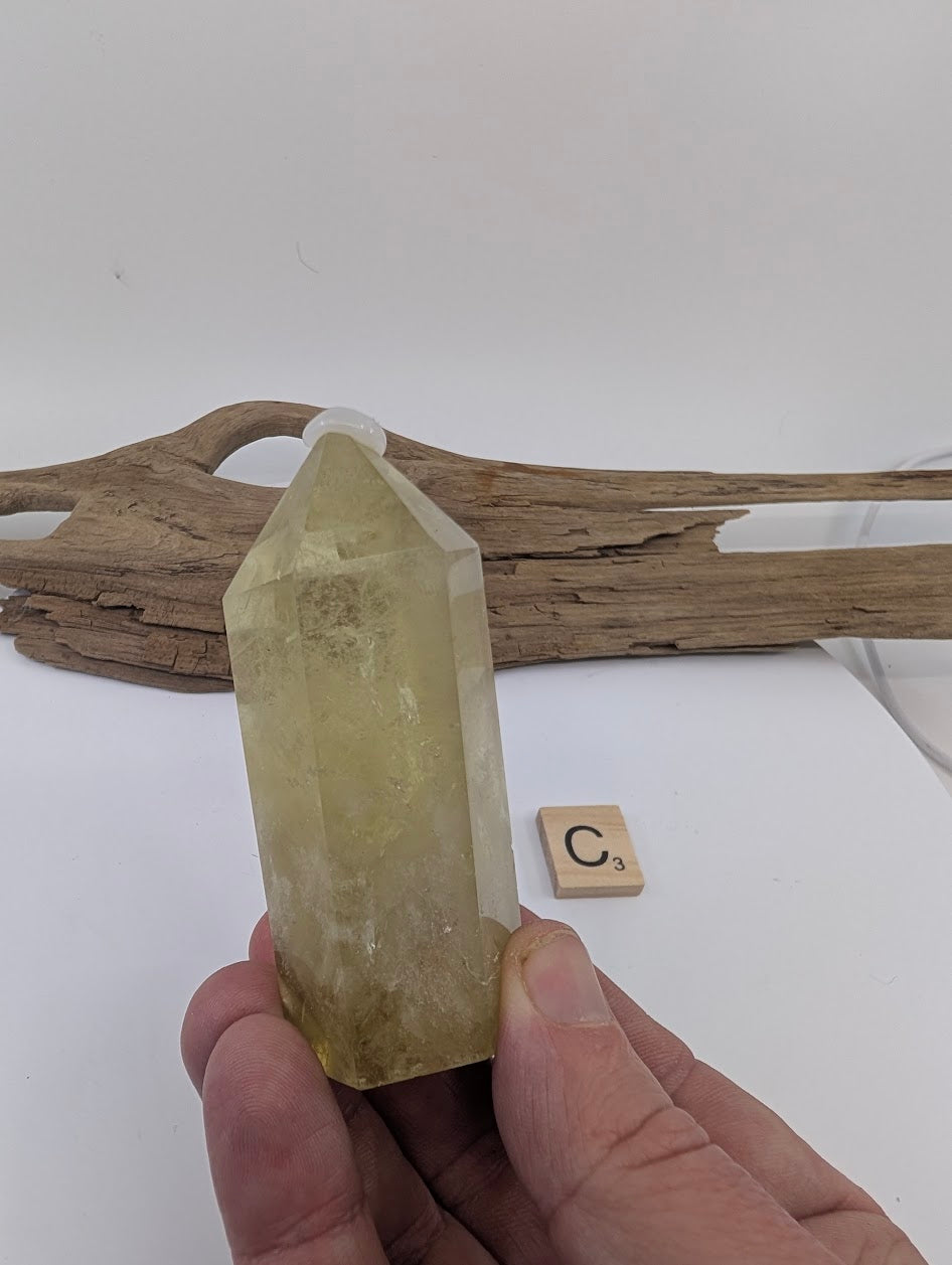 Hand holding Piece C, an 85mm chunky polished Smoky Citrine tower from Brazil.