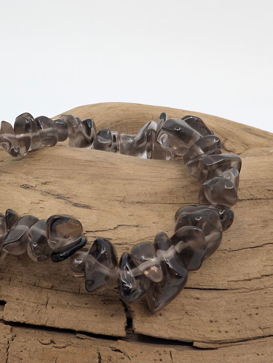 Closeup of smoky quartz chip bracelet showing polished, translucent grey chips
