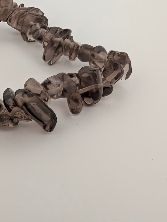 Detail of smoky quartz chips highlighting clarity and glassy polish