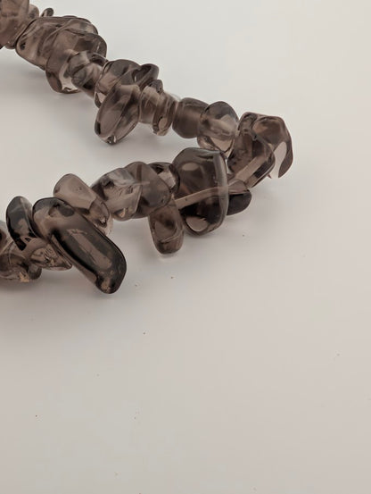 Detail of smoky quartz chips highlighting clarity and glassy polish
