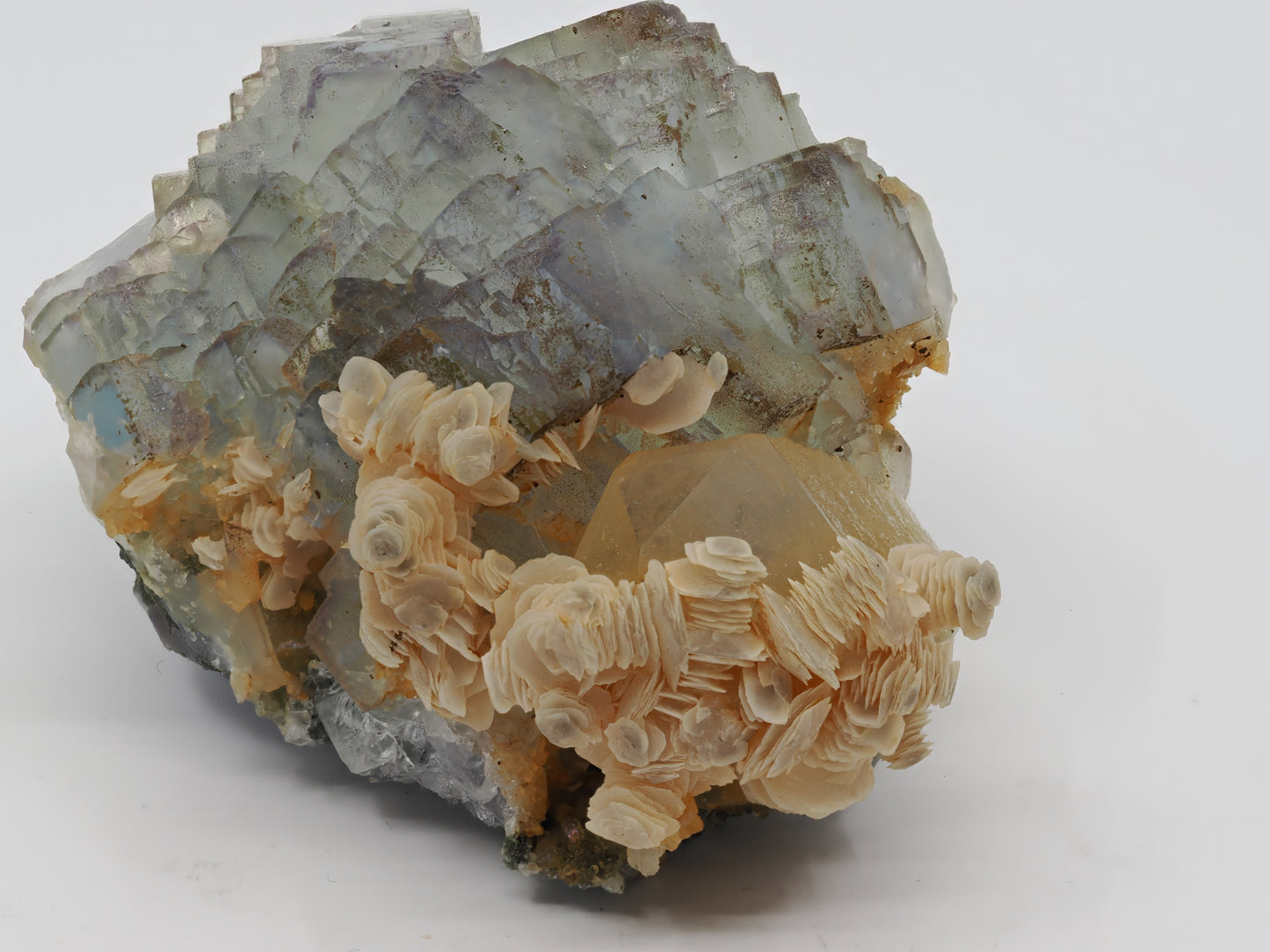 Side view of specimen showing terminated Smoky Quartz point acting as the anchor for Fluorite cubes and stacked Calcite blades.