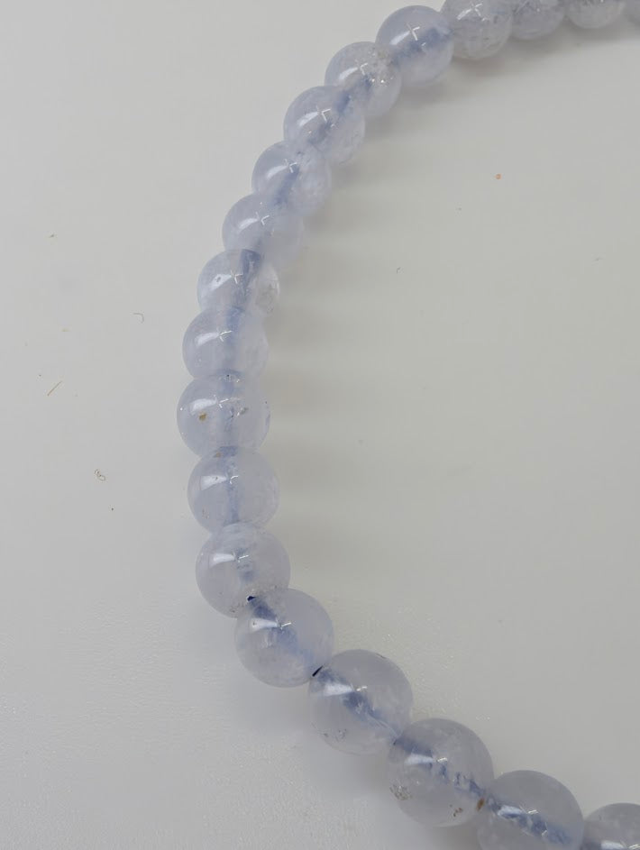 Detailed view of 4.5 mm Snowflake Blue Lace Agate beads showing natural pattern