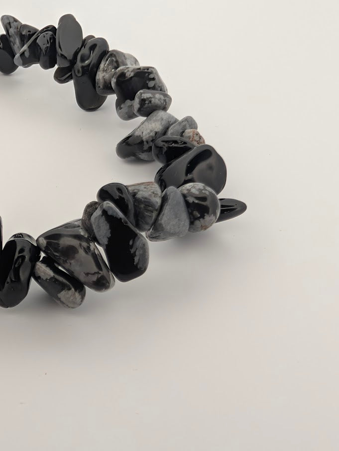 Close-up of Snowflake Obsidian chip bracelet with irregular stone textures