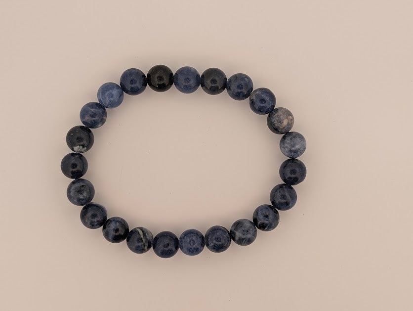 Polished 8MM sodalite round bead bracelet on neutral background