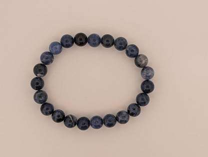 Polished 8MM sodalite round bead bracelet on neutral background