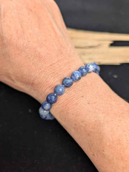 8mm faceted Sodalite beaded stretch bracelet worn on a wrist for size scale.