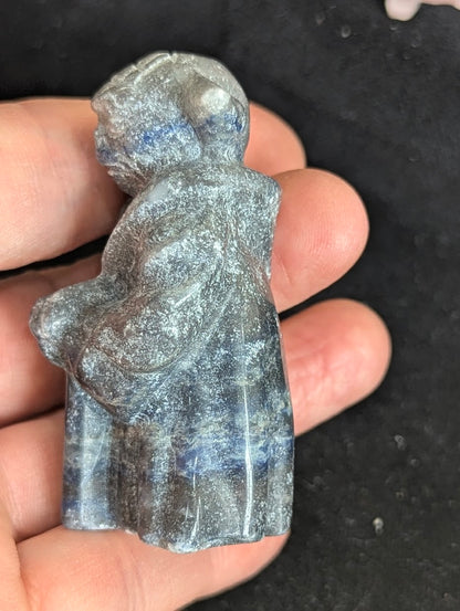 Close-up side view of a Sodalite Yoda figurine showcasing the natural texture and mineral depth.