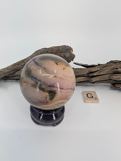Detail of soft grey and pink bands on a premium Mookaite sphere.