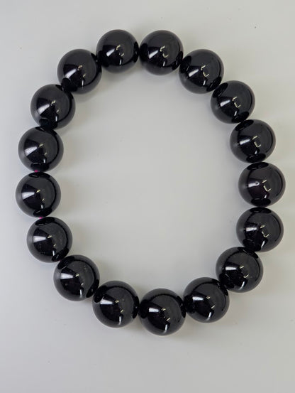 Overhead view of star flash garnet bracelet arranged in circle