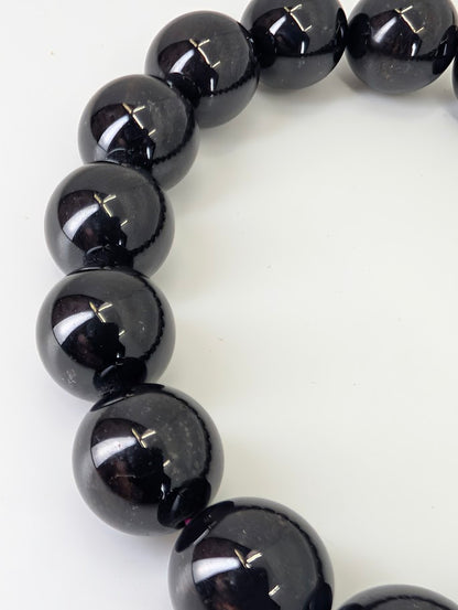 Detail photo showing subtle red inclusions and polish on garnet beads