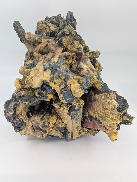 Stibnite cluster with sulfur, quartz druse, and realgar alteration from Jiangxi, 1.73 kg specimen front view.