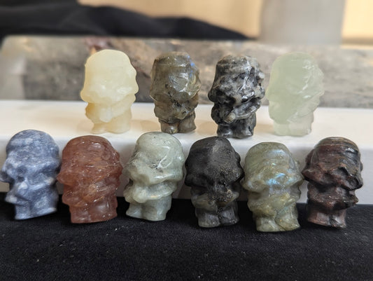 A group of ten precision-carved Storm Trooper totems in various natural minerals.