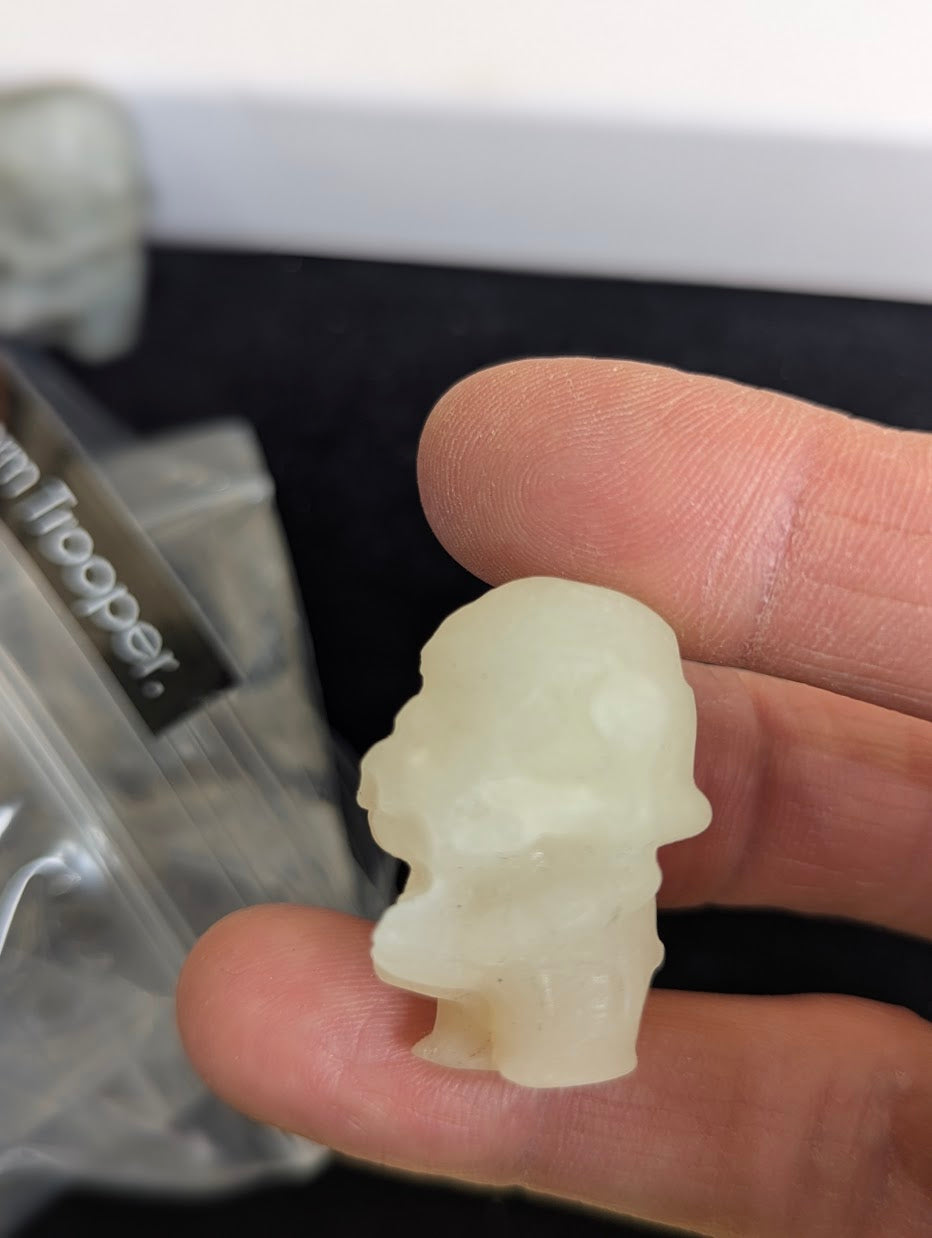 Side profile of a 3cm Yellow Jade Storm Trooper held in hand.