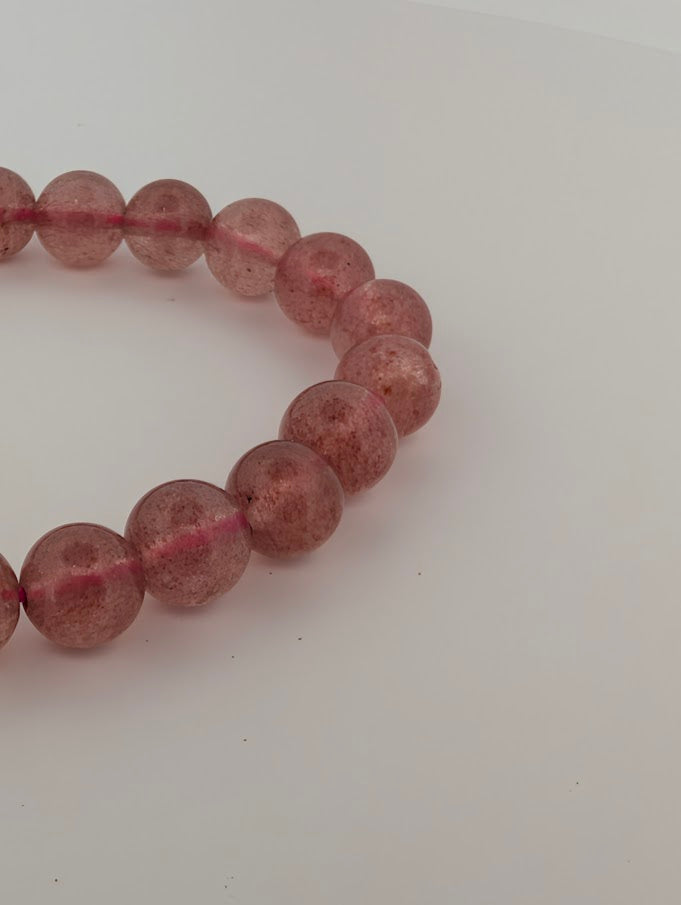 8mm Strawberry Quartz bracelet detail highlighting pink inclusion “confetti”