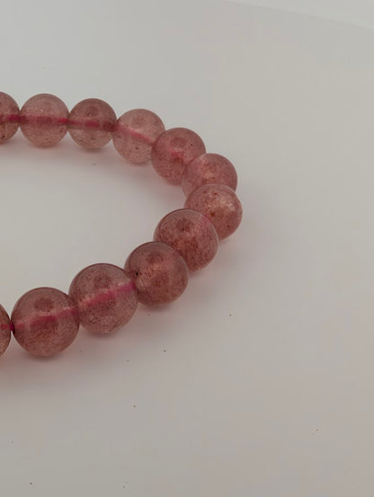 8mm Strawberry Quartz bracelet detail highlighting pink inclusion “confetti”
