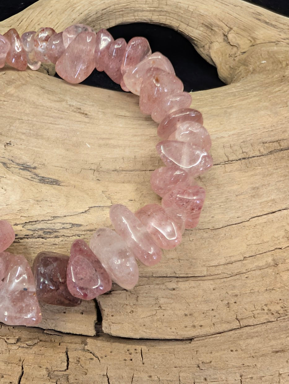 Close-up of organic Strawberry Quartz chip beads, highlighting the translucent pink color and natural internal speckles.