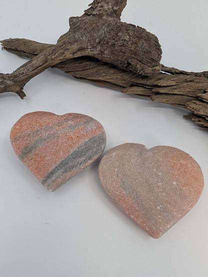 Pair of Peach Sunstone hearts with ruler showing approx 7cm width.