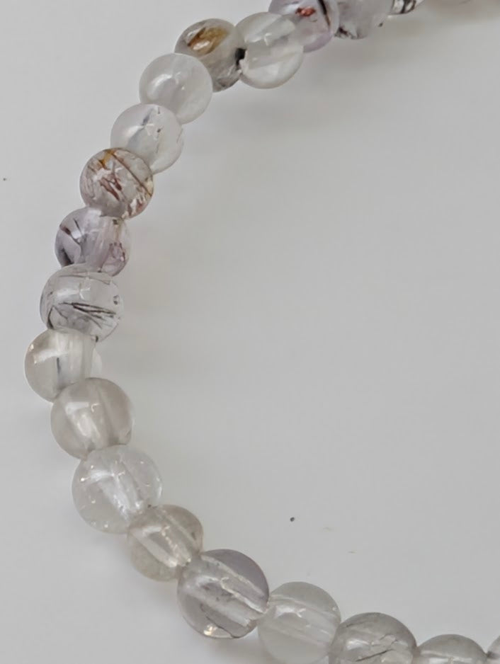 3 mm Super Seven bracelet displaying multi-mineral inclusions under light
