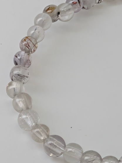 3 mm Super Seven bracelet displaying multi-mineral inclusions under light